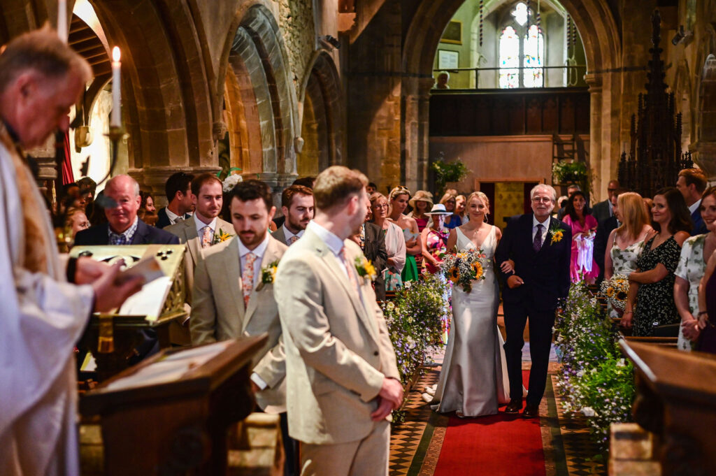 Photograph of bride walking down the aisle at Market Harborough wedding